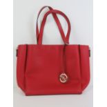 A red ladies tote bag 4" high x 11 1/2" wide made by HRX.