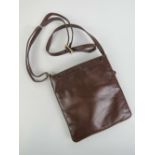 A brown leather handbag with label for Alpha 8" deep, 7.5" wide.