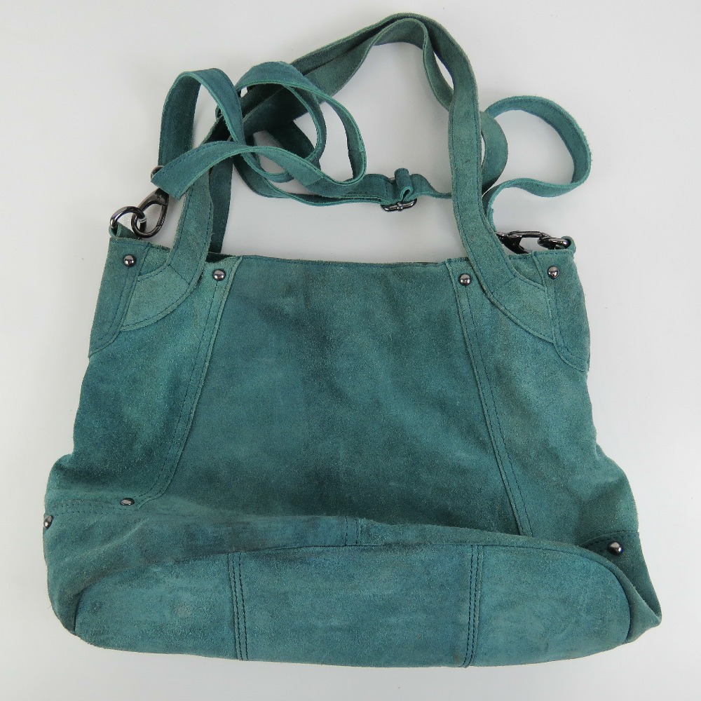 A vintage turquoise blue suede handbag.