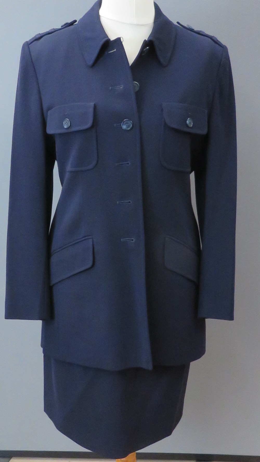 Jaeger; A navy blue 100% new pure wool jacket and skirt, jacket having breast pockets and epaulets,