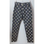 Paule Vasseur Paris; a pair of ladies trousers having embroidered Napoleonic bee on black ground,