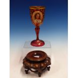 A BOHEMIAN GILT RUBY GLASS GOBLET ON A CHINESE WOOD STAND.