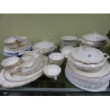 A DOULTON RICHELIEU PATTERN DINNER SERVICE, EACH PIECE GILT WITH A WAVY FOLIAGE RIMS BAND,