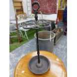 A CAST IRON STICK STAND, A RING HANDLE ABOVE SNAKES FORMING CIRCLES ABOVE THE CLUSTER COLUMN AND