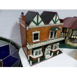 A VINTAGE PAINTED DOLL'S HOUSE, DOUBLE GABLE ROOF ABOVE BALCONY AND TWO BAY WINDOWS. W.67 x H.