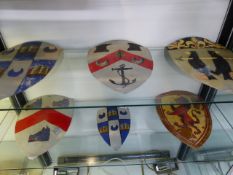 A GROUP OF SIX HAND PAINTED ARMORIAL SHIELD FORM WALL PLAQUES. (6)