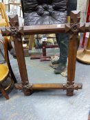 A VICTORIAN GOTHIC REVIVAL OAK FRAMED WALL MIRROR. 65 x 75cms.