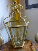 A LARGE GILT BRASS HEXAGONAL HANGING HALL LANTERN. H.87cms.