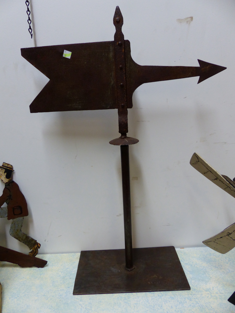 AN IRON WEATHER VANE IN THE FORM OF A PENNANT AND ARROW, NOW MOUNTED ON A RECTANGULAR BASE. H