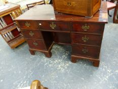 AN ANTIQUE GEORGIAN STYLE MAHOGANY PEDESTAL DESK, THE QUARTER VENEERED TOP CROSS BANDED, THE CENTRAL