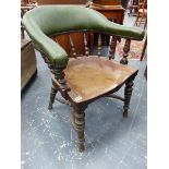 AN ANTIQUE TUB FORM DESK CHAIR WITH SPINDLE SUPPORTS AND SHAPED SOLID SEAT.