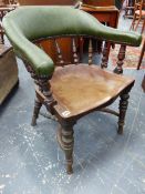 AN ANTIQUE TUB FORM DESK CHAIR WITH SPINDLE SUPPORTS AND SHAPED SOLID SEAT.