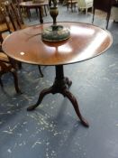 A GEORGIAN MAHOGANY TILT TOP TRIPOD TABLE, THE DISHED CIRCULAR TOP ABOVE LONG NOSED CLUB FEET.