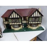 A LARGE PAINTED TUDOR STYLE DOUBLE FRONTED DOLL'S HOUSE WITH PINE TABLE/STAND. HOUSE W.120 x H.