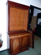 A CARVED MAHOGANY EARLY VICTORIAN BOOKCASE WITH MOULDED CORNICE ABOVE TWO GLAZED DOORS, THE BASE