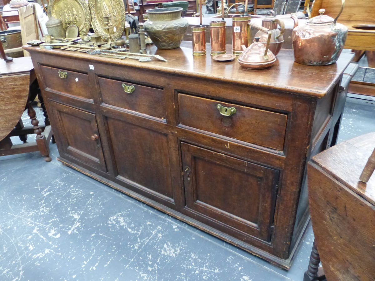 A GEORGIAN PINE DRESSER THE THREE DRAWERS WITH BRASS HANDLES ABOVE TWO CUPBOARDS FLANKING A