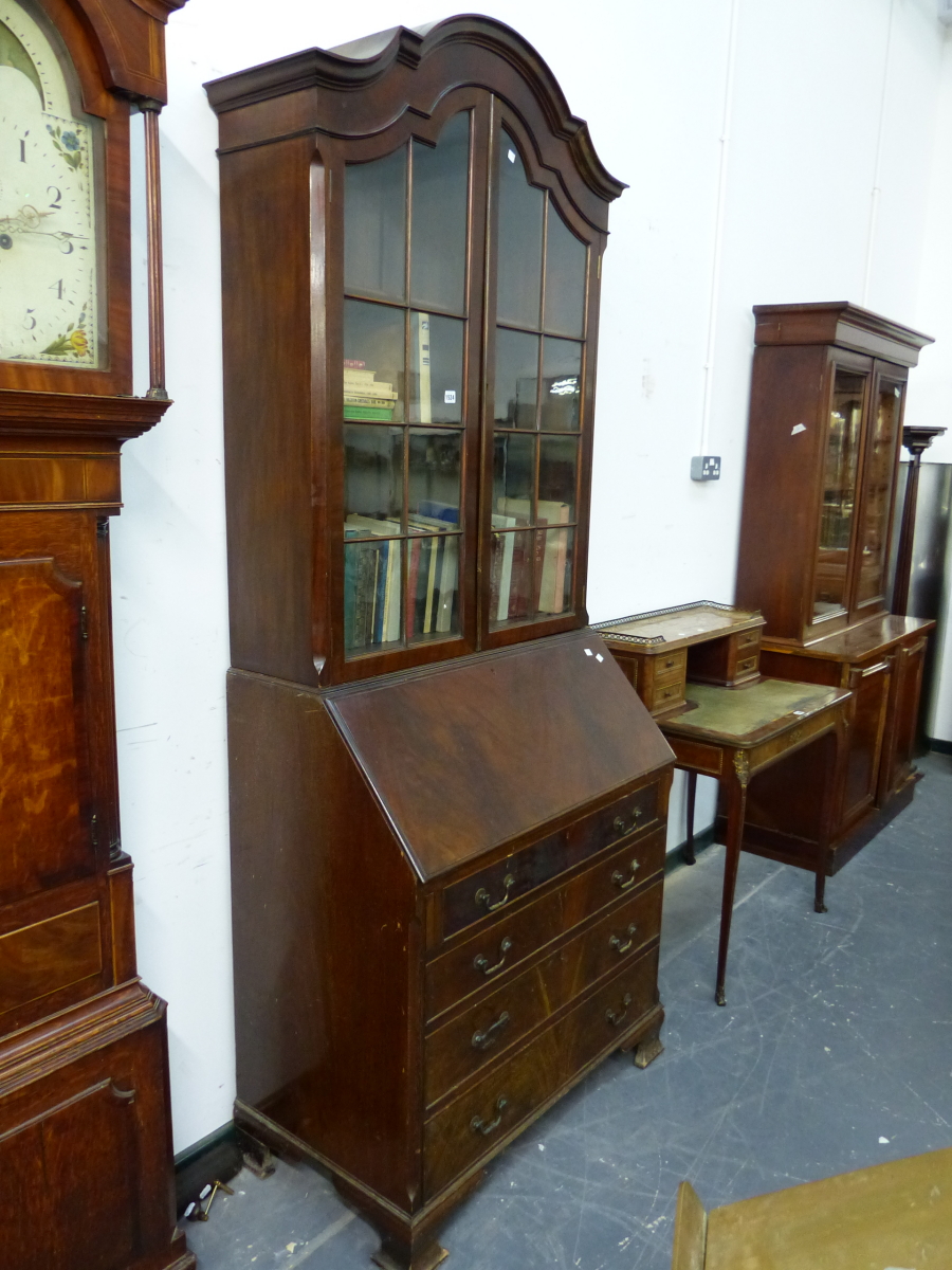 A GEORGIAN STYLE MAHOGANY BUREAU BOOK CASE, THE SHAPED SERPENTINE CORNICE OVER DOORS GLAZED WITH