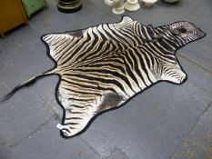 A BLUE CLOTH MOUNTED ZEBRA SKIN. W 280cms.