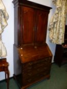 A GEORGIAN AND LATER COUNTRY MADE MAHOGANY BUREAU BOOKCASE CABINET WITH TWO PANEL DOORS ENCLOSING