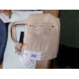 A RADLEY PALE PINK LEATHER BAG SEWN WITH OCHRE, RUSSET AND GREEN KNOTS TO ONE SIDE, THE SCOTTIE