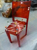 A RED PERSPEX SIDE CHAIR WITH DKNY LABEL TOGETHER WITH TWO RETRO COAT HANGERS.