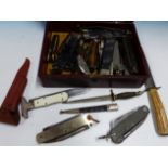 A JAPANESE LACQUER BOX OF PENKNIVES, FOLDING KNIVES AND TWO DAGGERS.