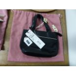 A RADLEY BLACK LEATHER HANDBAG WITH WHITE POLKA DOT ZIP PULL AND LINING TOGETHER WITH A PINK TEXTILE