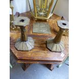 A PAIR OF ARTS AND CRAFTS CANDLESTICKS AND AN EMBOSSED BRASS PANEL.