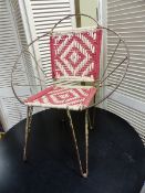 A WIRE FRAMED RETRO ARMCHAIR.