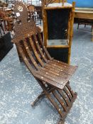 AN EASTERN HARDWOOD CARVED AND INLAID FOLDING SIDE CHAIR ON SHAPED SUPPORTS.