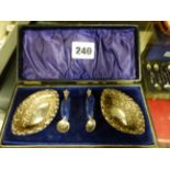 A CASED PAIR OF SILVER SALTS WITH SPOONS.