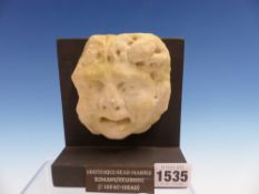 A ROMAN HELLENISTIC STONE GROTESQUE HEAD MASK c.100BC-100AD. H.10cms.