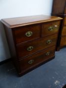 A VICTORIAN MAHOGANY CHEST OF TWO SHORT AND TWO LONG DRAWERS EACH WITH BRASS OVAL LION MASK BACK
