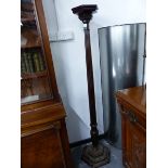 A MAHOGANY TORCHERE, THE HEXAGONAL TOP ON A REEDED COLUMN FLARING TO A BALUSTER ABOVE THE STEPPED