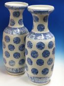 A PAIR OF CHINESE BLUE AND WHITE BALUSTER VASES PAINTED WITH PHOENIX ROUNDELS BETWEEN BANDS OF