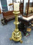 A 1902 MEMORIAL LARGE BRASS FLOOR STANDING CANDLESTICK, THE GALLERIED TOP ON KNOPPED SPIRAL TURNED