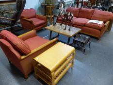 A BEECH AND MAHOGANY THREE PIECE SUITE UPHOLSTERED IN DEEP TERRACOTTA RED, THE MAHOGANY ARM FRONTS