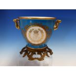 A SEVRES TWO HANDLED BLUE GROUND CACHE POT WITH ROCOCO ORMOLU FOOT AND ONE SIDE PAINTED WITH THE