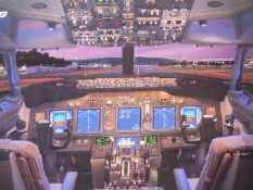 A LARGE FOLIO COLOUR PRINT OF A BOEING 737 COCKPIT TOGETHER WITH ANOTHER PICTURE OF A JAGUAR