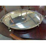 A SILVER ON COPPER TWO HANDLED GALLERIED OVAL TRAY ON FOUR PAW FEET. W 71cms.