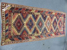 AN ANTIQUE KAZAK RUG. 250 x 107cms.