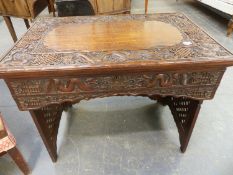 AN ANTIQUE CHINESE HARDWOOD WRITING TABLE WITH RISING TOP AND FITTED INTERIOR CARVED WITH DRAGON