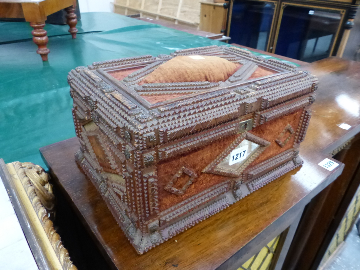 A TRAMP ART CASKET, THE CHIP CARVED WOOD WORK EDGING BROWN VELVET, THE FRONT AND BACK WITH CENTRAL