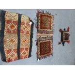 TWO BELOUCH TRIBAL SADDLE BAGS. AND A FLAT WEAVE PANEL. (3)