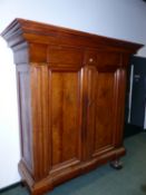 AN EARLY CONTINENTAL WALNUT BAROQUE STYLE ARMOIRE OF HEAVY CONSTRUCTION WITH MOULDED CORNICE, TWIN