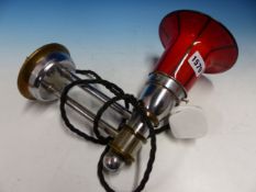 A MID 20th C. GERMAN WALL LIGHT, THE BLACK STRIPED RED GLASS SHADE CLAMPING INTO CHROME FITTINGS.