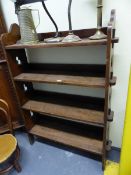 AN ARTS AND CRAFTS OAK OPEN BOOK CASE WITH THE FOUR SHELVES PEGGED INTO SIDES PIERCED WITH TREFOILS.