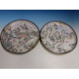 A PAIR OF CANTON ENAMEL DISHES PAINTED WITH FIGURES IN MOUNTAINOUS ISLAND SCENES. Dia. 26.5cms.
