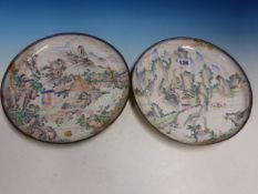 A PAIR OF CANTON ENAMEL DISHES PAINTED WITH FIGURES IN MOUNTAINOUS ISLAND SCENES. Dia. 26.5cms.