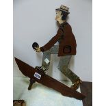 A PAINTED IRON WEATHER VANE, THE SHEET CUT OUT TO REPRESENT A MAN PLAYING BOWLS. 40 x 36cms.